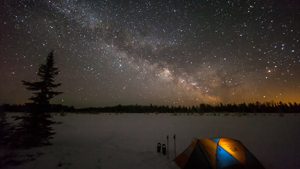 Tent camping under a rising Milky Way in Voyegeur's National Park in Minnesota.
