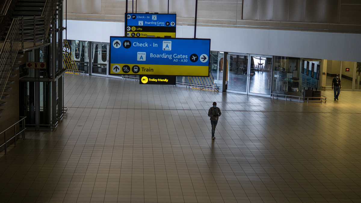 A man walks through a deserted part of Johannesburg's OR Tambo's airport in South Africa.