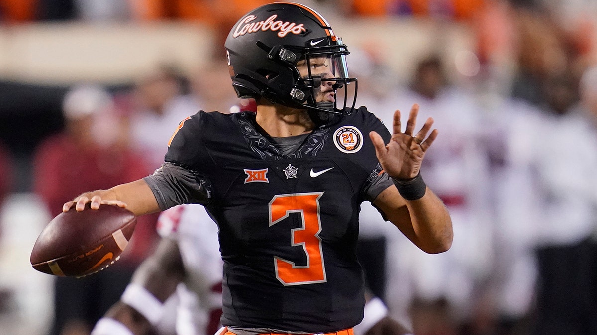 Oklahoma State quarterback Spencer Sanders looks for a receiver during the first half of the team's NCAA college football game against Oklahoma, Saturday, Nov. 27, 2021, in Stillwater, Oklahoma. 