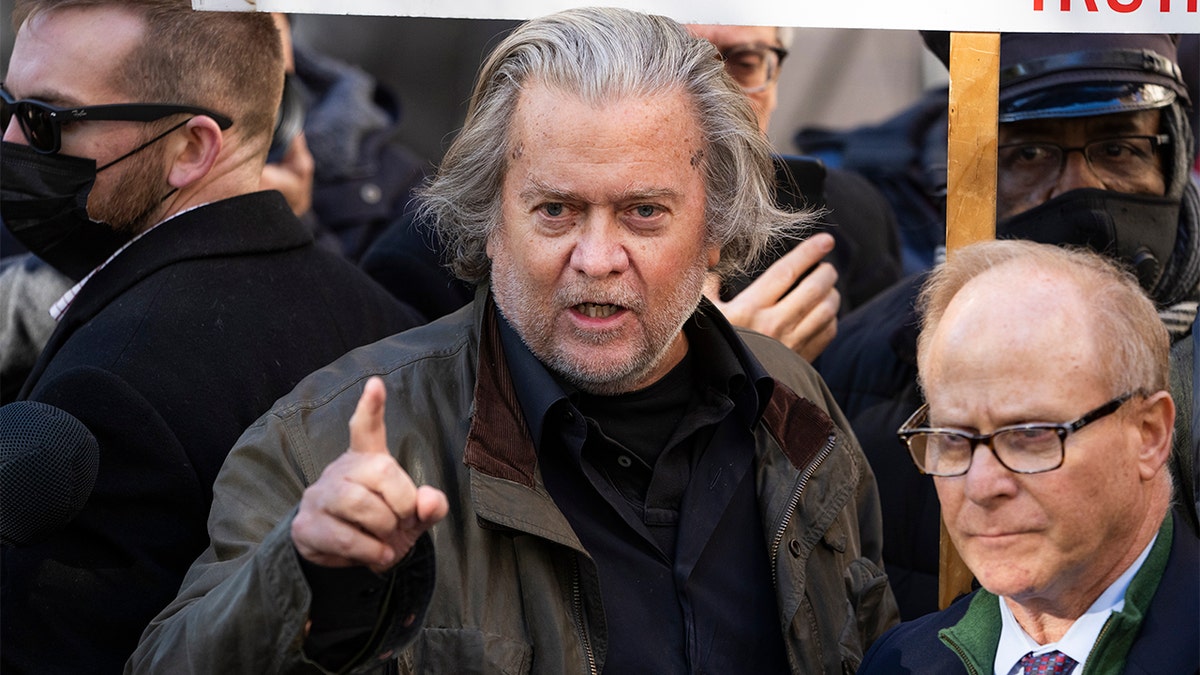 Steve Bannon, left, former adviser to President Trump, and his attorney David Schoen, address the media after an appearance at the E. Barrett Prettyman Federal Courthouse on contempt of Congress charges for failing to comply with a subpoena from the committee investigating the Jan. 6 riot, on Monday, Nov. 15, 2021.