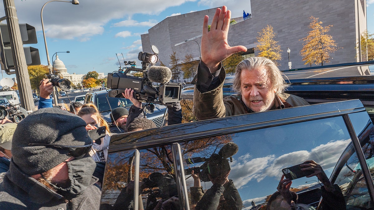 Steve Bannon, former adviser to President Trump, waves to members of the media as he departs federal court in Washington, D.C., on Monday, Nov. 15, 2021.