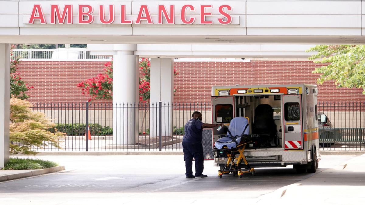 An ambulance driver disinfects a stretcher after unloading a patient on Aug. 13 at a Memphis children's hospital, after Memphis Fire Chief Gina Sweat said that emergency services were overwhelmed by numbers of coronavirus disease patients and that wait times should be expected. 