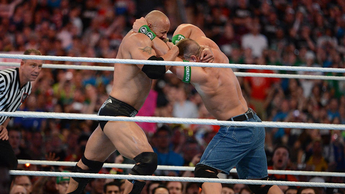Dwayne ''The Rock'' Johnson and John Cena in action during WrestleMania XXVIII at Sun Life Stadium on April 1, 2012, in Miami Gardens, Florida.