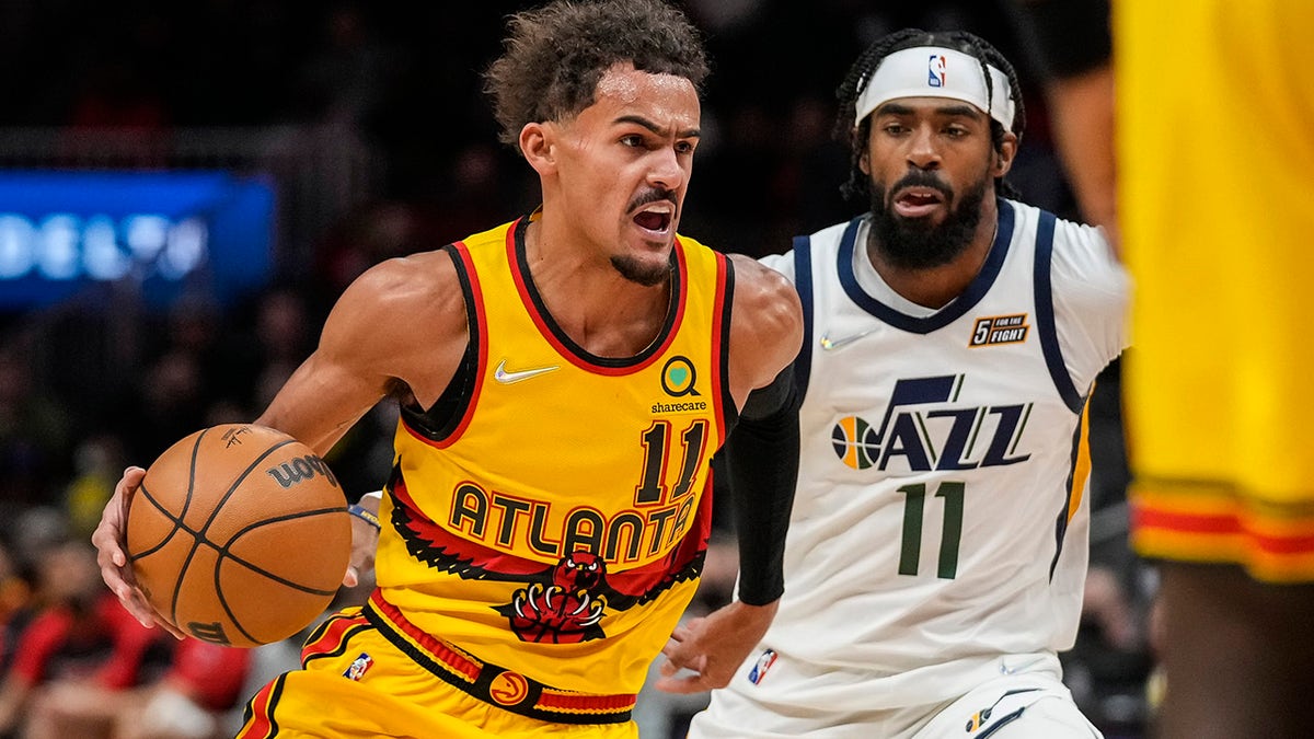 Atlanta Hawks guard Trae Young (11) dribbles past Utah Jazz guard Mike Conley (11) during the first quarter Nov. 4, 2021, at State Farm Arena in Atlanta, Ga.