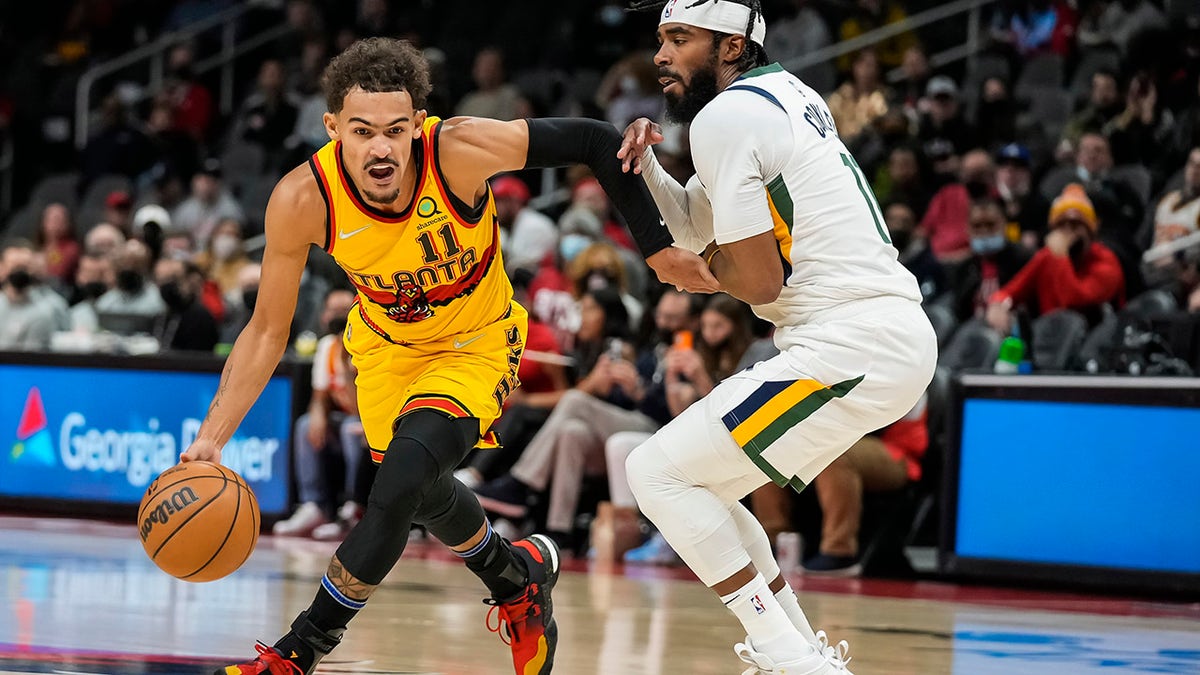 Atlanta Hawks guard Trae Young (11) works to get past Utah Jazz guard Mike Conley (11) during the first half Nov. 4, 2021, at State Farm Arena in Atlanta, Georgia.