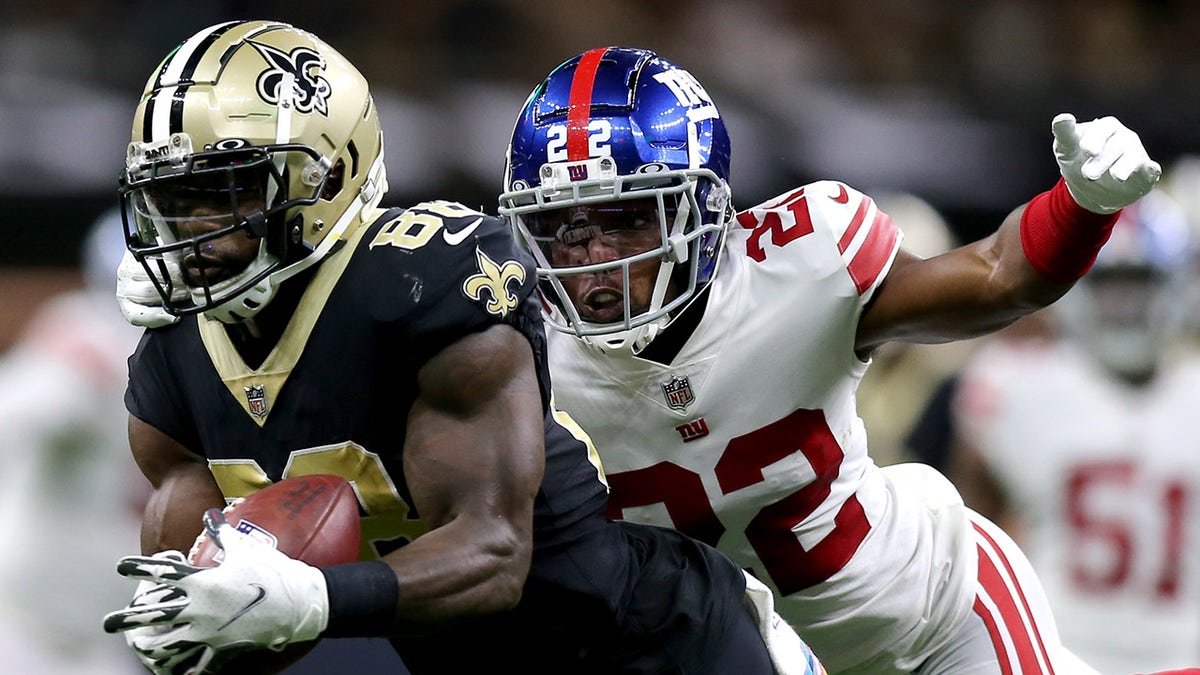 Ty Montgomery #88 of the New Orleans Saints catches a ball while being chased by Adoree' Jackson #22 of the New York Giants during the second quarter at Caesars Superdome on October 03, 2021 in New Orleans, Louisiana.