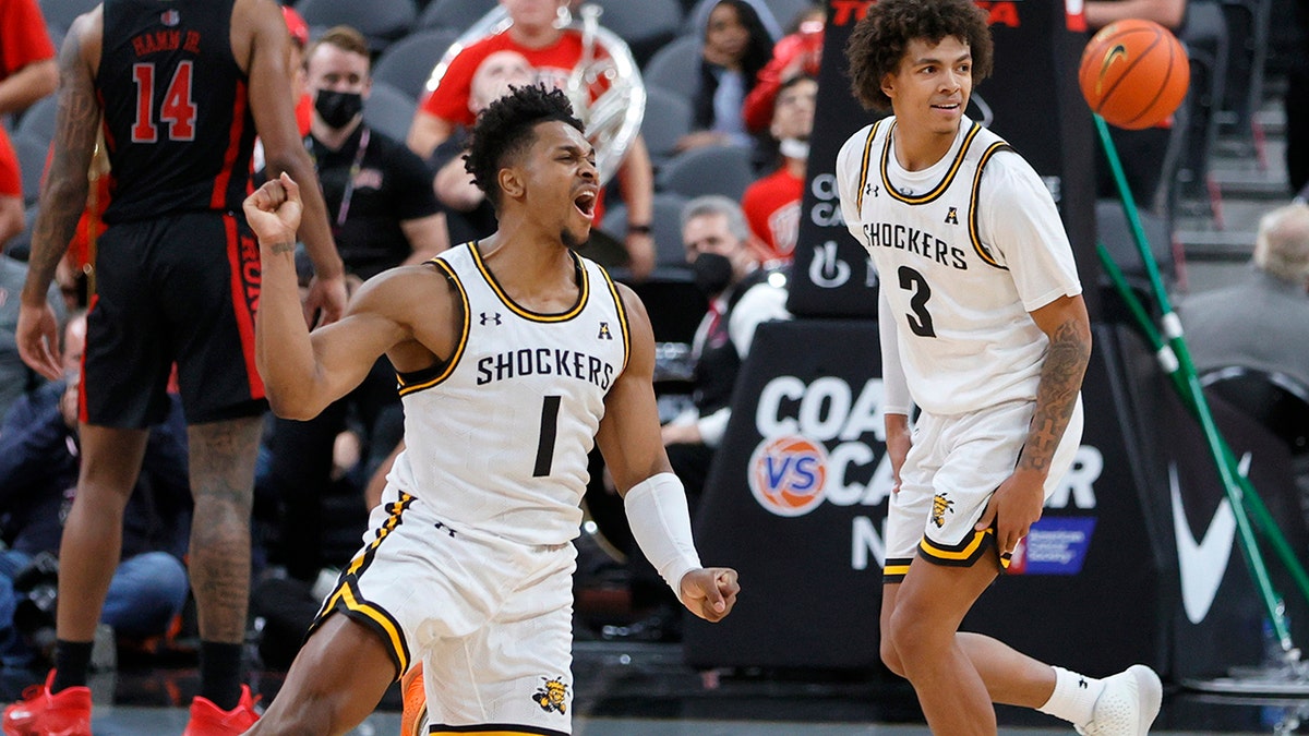 Shockers Tyson Etienne (1) and Craig Porter Jr. react after the team's 74-73 victory over the Rebels at T-Mobile Arena on Nov. 21, 2021, in Las Vegas, Nevada. 
