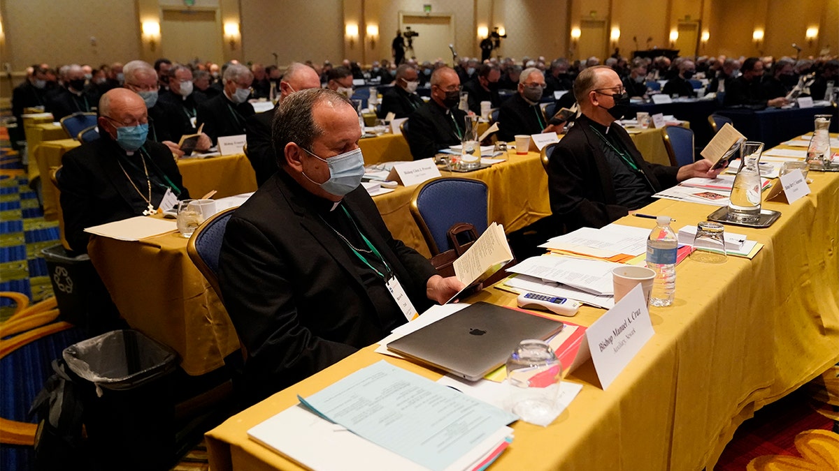 Bishop Manuel Cruz, front left, of the Archdiocese of Newark, New Jersey, during a morning prayer at the Fall General Assembly of the U.S. Conference of Catholic Bishops, Wednesday, Nov. 17, 2021, in Baltimore.