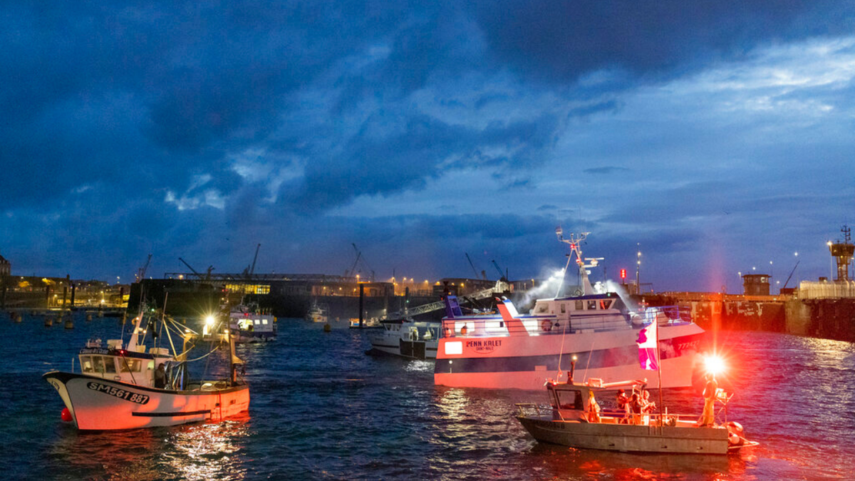 French fishing boats block the entrance to the port of Saint-Malo, western France, Friday, Nov. 26, 2021. French fishing crews are threatening to block French ports and traffic under the English Channel on Friday to disrupt the flow of goods to the U.K., in a dispute over post-Brexit fishing licenses.
