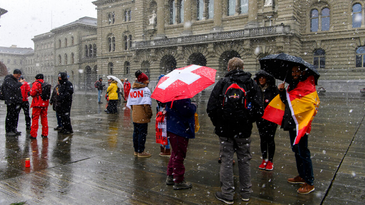 People protest during a rally by opponents of the COVID-19 law, in Bern, Switzerland, on Sunday, Nov. 28, 2021. 