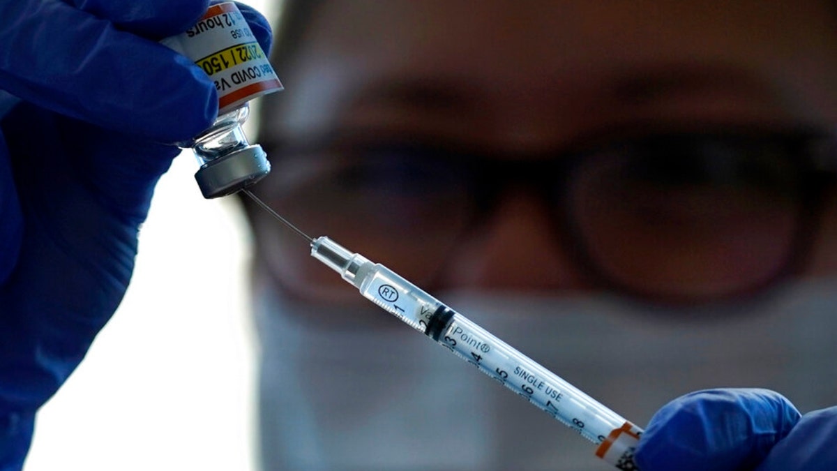 Lurie Children's hospital registered nurse Carolyn Ruyle prepares a dose of a Pfizer COVID-19 vaccine at Lurie Children's hospital Friday, Nov. 5, 2021, in Chicago. (AP Photo/Nam Y. Huh) 