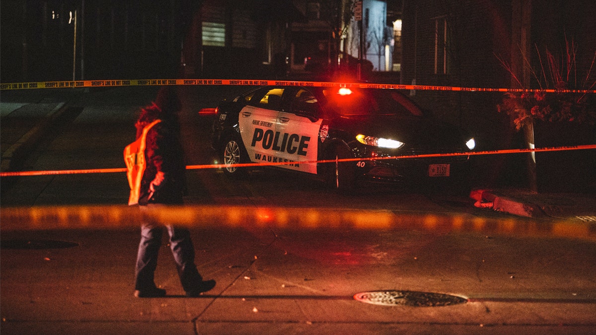 Police tape limits access to the scene of Sunday's Christmas parade tragedy in Waukesha, Wisconsin, Nov. 21, 2021.