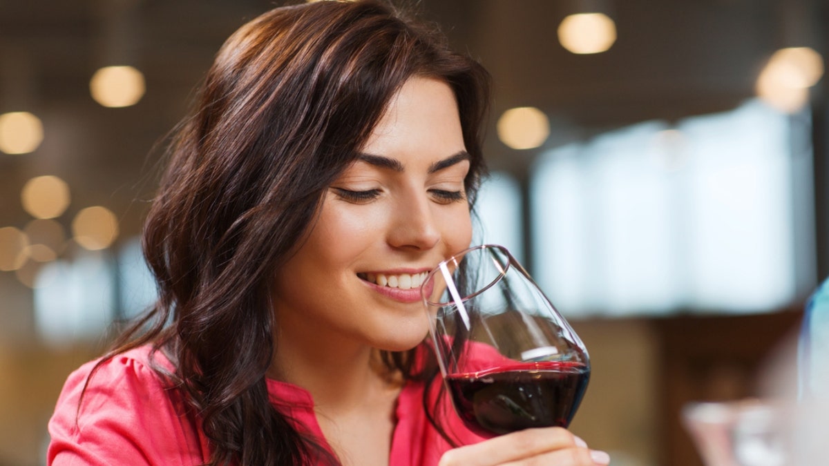 A woman drinking a glass of wine