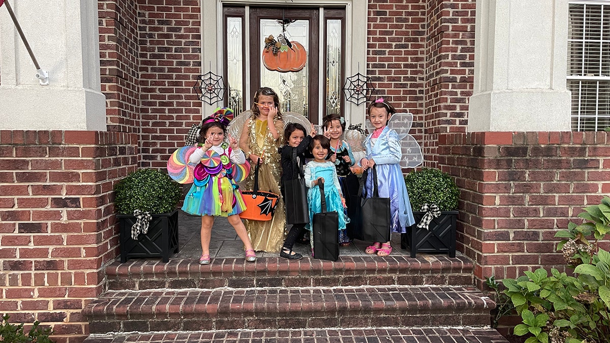 Muzhdah, Muzhgan, and Asra trick-or-treating with their new American friends