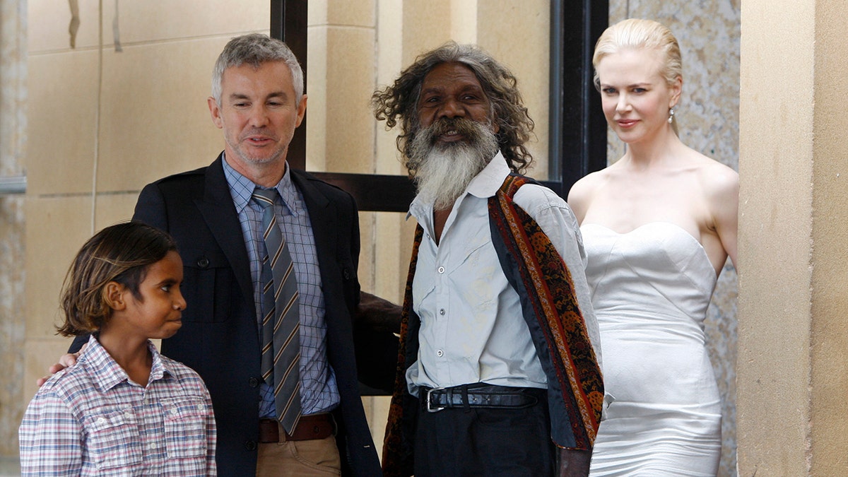 Australian Indigenous actor David Gulpilil, second right, film director Baz Luhrmann, second left, walks with actors Brandon Walters left, and Nicole Kidman right, following a press conference for their latest movie, Australia, in Sydney, Tuesday, Nov. 18, 2008. Gulpilil has died of lung cancer, a government leader said on Monday, Nov. 29, 2021. He was 68 years old.