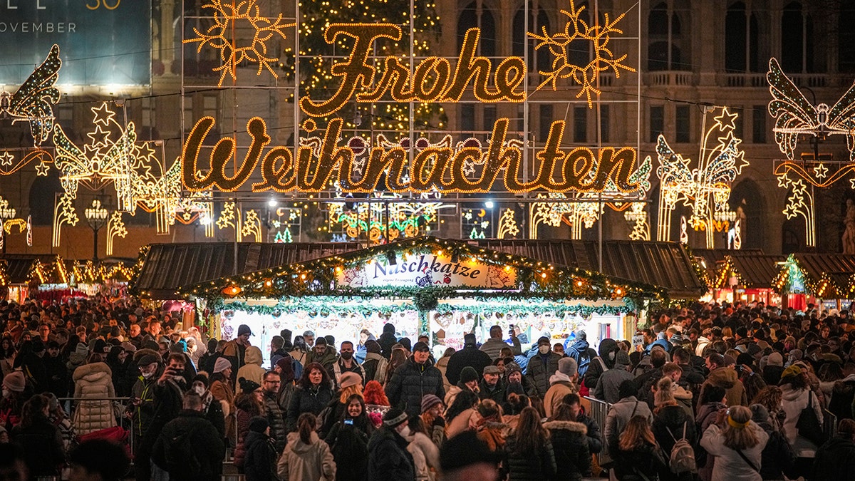 People crowd a Christmas market in Vienna, Austria, Sunday, Nov. 21, 2021. 