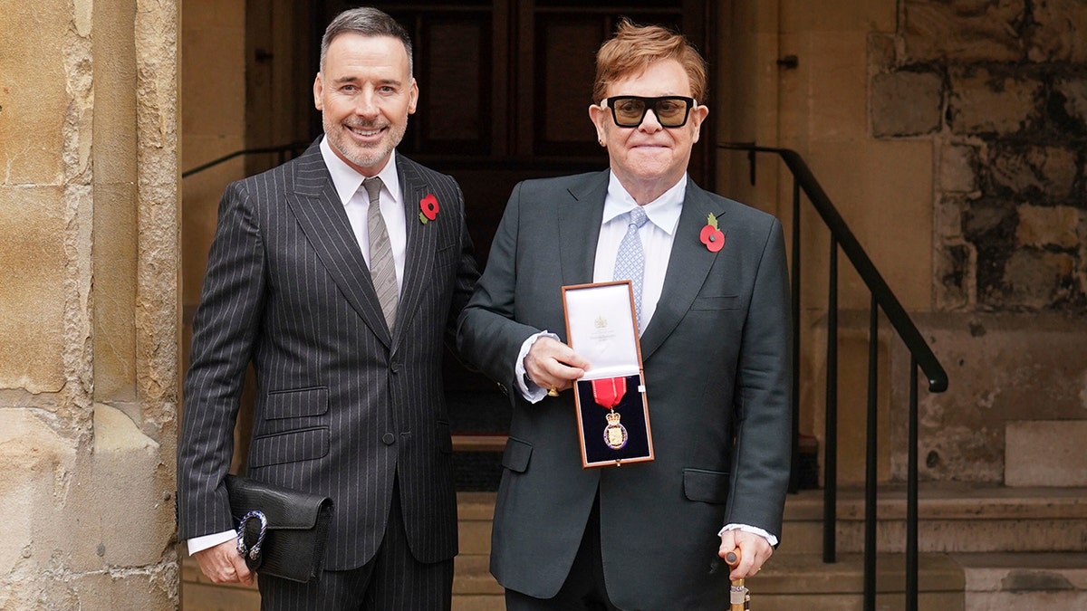 Sir Elton John with his partner David Furnish, after being made a member of the Order of the Companions of Honour for services to music and to charity during an investiture ceremony at Windsor Castle, in Windsor, England, on Nov. 10, 2021.