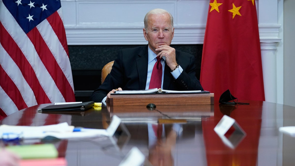 President Biden listens as he meets virtually with Chinese President Xi Jinping at the White House on Monday, Nov. 15, 2021.