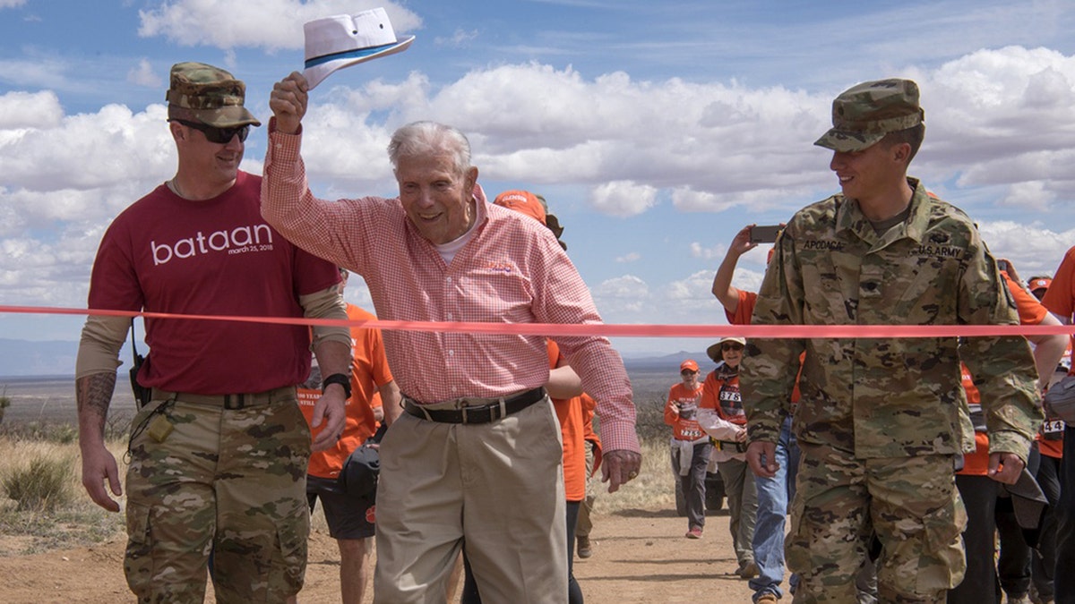 Skardon crosses the 8.5-mile finish line of the Bataan Memorial Death March at White Sands Missile Range, N.M., in 2018.?