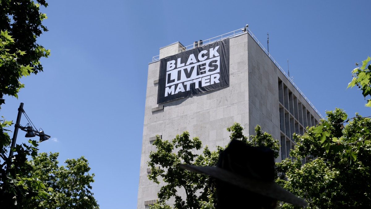 A ‘Black Lives Matter’ banner is displayed on the building of the U.S. Embassy in Spain, on May 25, 2021 in Madrid, Spain.?