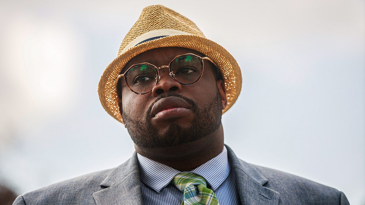 Vauhxx Booker listens during a press conference after a special prosecutor charged him with felony assault and trespassing over a year after he was attacked in July 2020 at Lake Monroe, at the Monroe County Courthouse in Bloomington, Indiana.