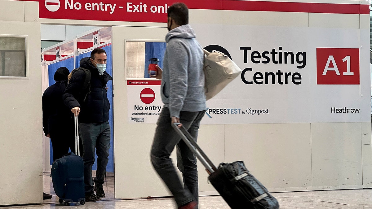 Passengers get a COVID-19 test at a Testing Centre at Heathrow Airport in London, Monday, Nov. 29, 2021. 