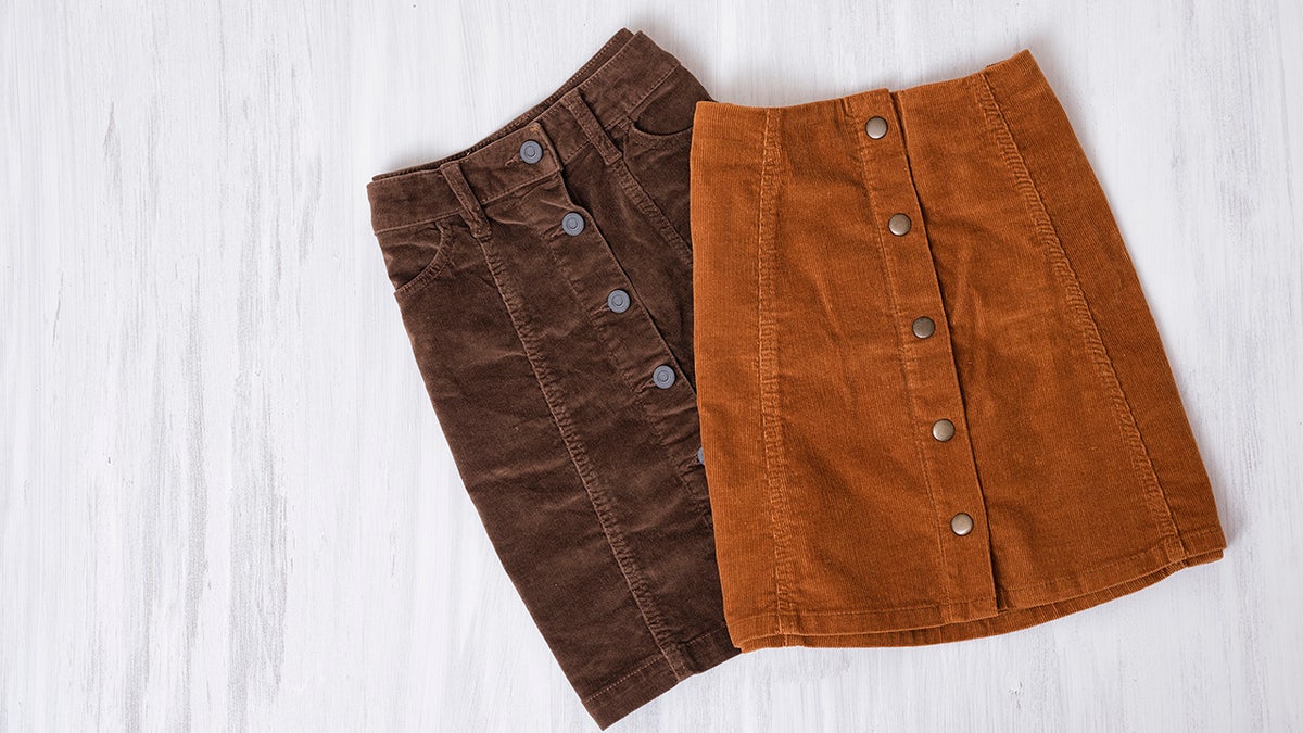 Two  brown skirts on a wooden background. Fashion concept
