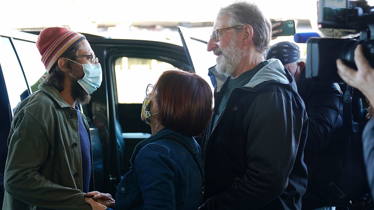 Danny Fenster is greeted by his parents, Rose and Buddy Fenster, after he arrived at John F. Kennedy Airport in New York, Tuesday, Nov. 16, 2021. 