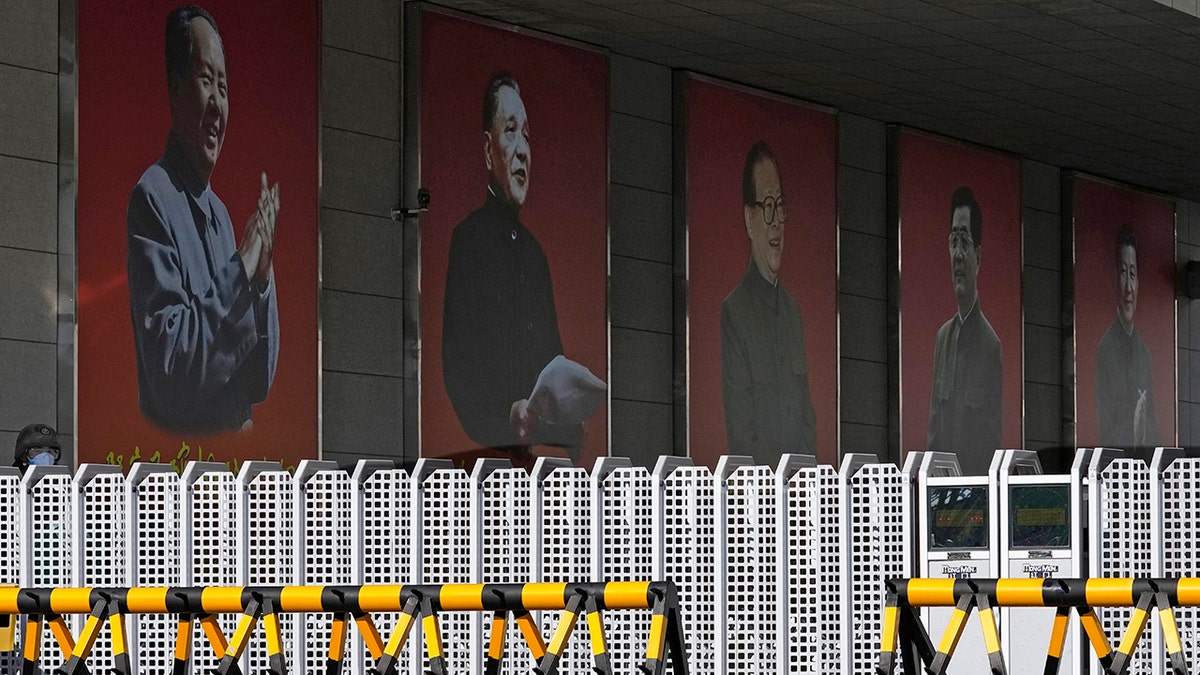 Portraits of China's former top leaders (from left) Mao Zedong, Deng Xiaoping, Jiang Zemin, Hu Jintao and President Xi Jinping are seen at a military camp in Beijing, China, on Thursday, Nov. 11, 2021.