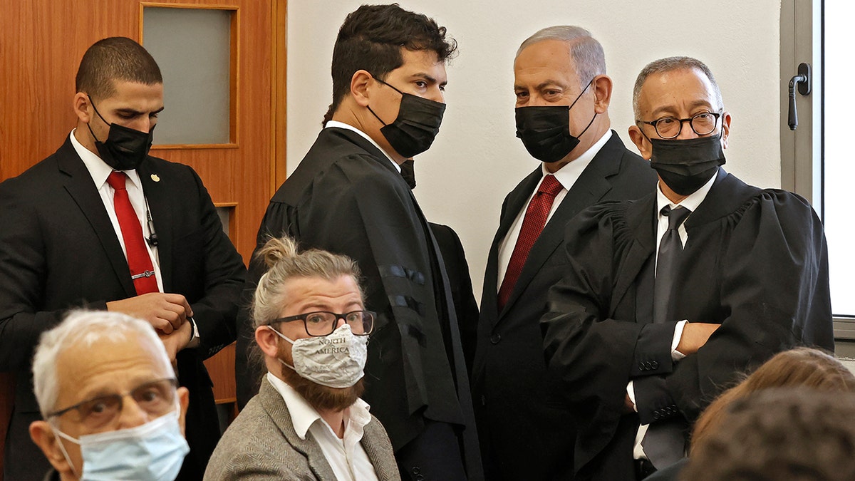 Former Israeli prime minister Benjamin Netanyahu, second right, arrives for a court hearing on corruption charges on Tuesday, Nov. 16, 2021, in Jerusalem. 