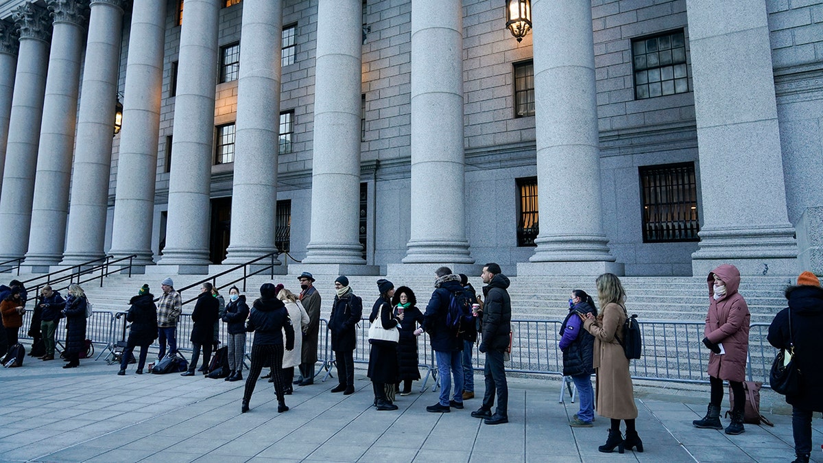 A line of people, mostly journalists, wait to enter the courthouse for the start of the Ghislaine Maxwell trial in New York on Monday, Nov. 29, 2021. 