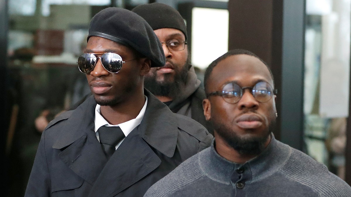 Brothers Olabinjo Osundairo, right, and Abimbola Osundairo, appear outside the Leighton Criminal Courthouse in Chicago, Feb. 24, 2020.