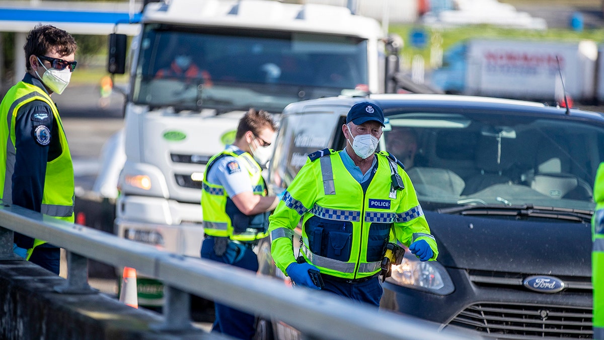 Police inspect vehicles at a road block on the outskirts of Auckland, New Zealand on Sept. 30, 2021. 
