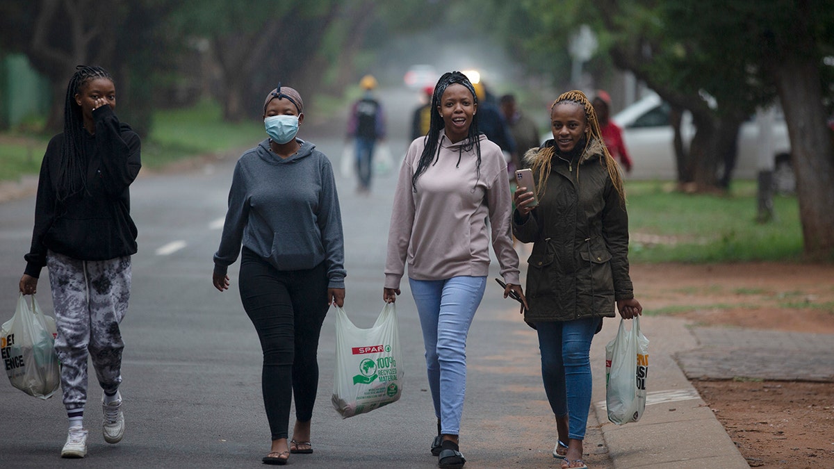 Students from the Tshwane University of Technology make their way back to their residence in Pretoria, South Africa, on Saturday, Nov. 27, 2021.