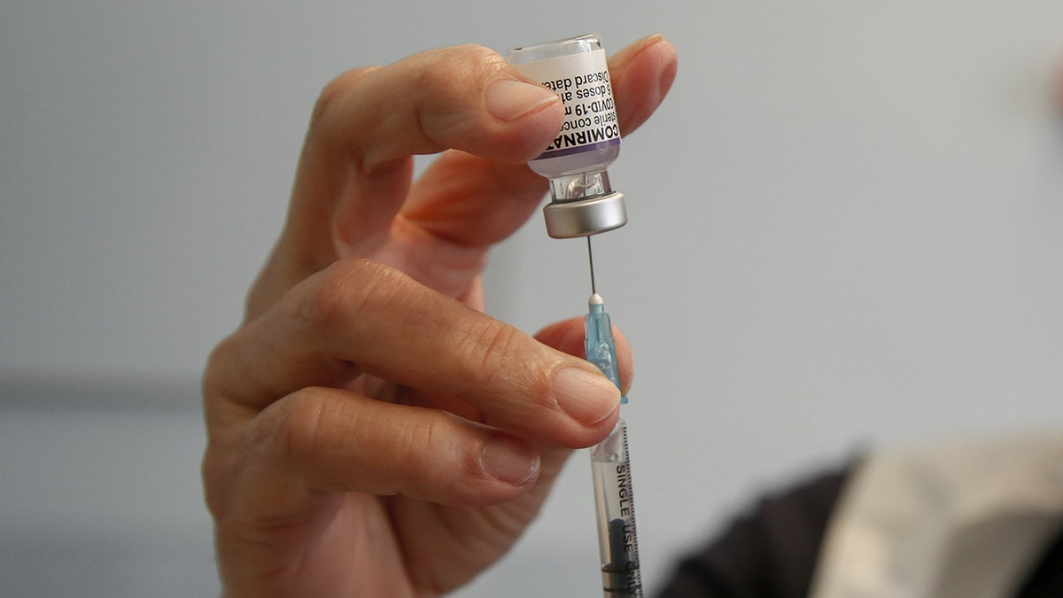 A health worker in the U.K. prepares to administer a dose of Pfizer/BioNTech COVID-19 vaccine at a vaccination center. Soon, children in the United States may be able to receive the COVID-19 vaccine.