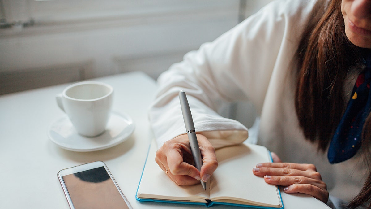 Person writing in journal