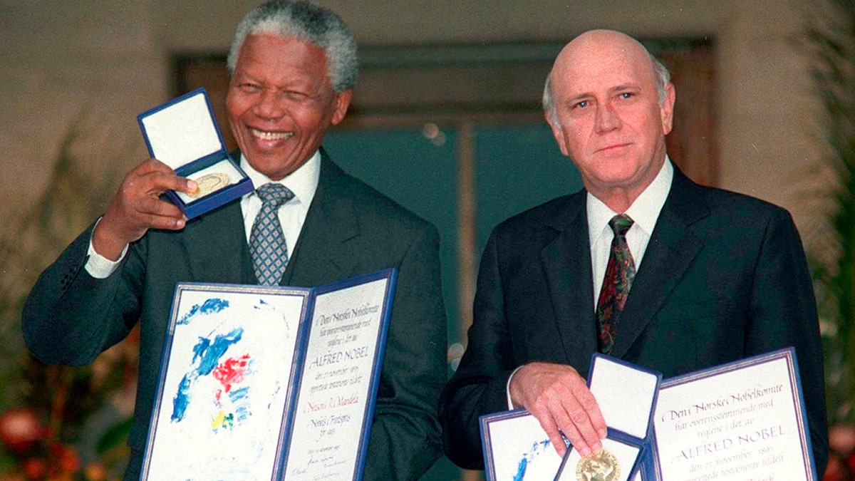 South African Deputy President F.W. de Klerk, right, and South African President Nelson Mandela pose with their Nobel Peace Prize Gold Medal and Diploma, in Oslo in December 1993. 