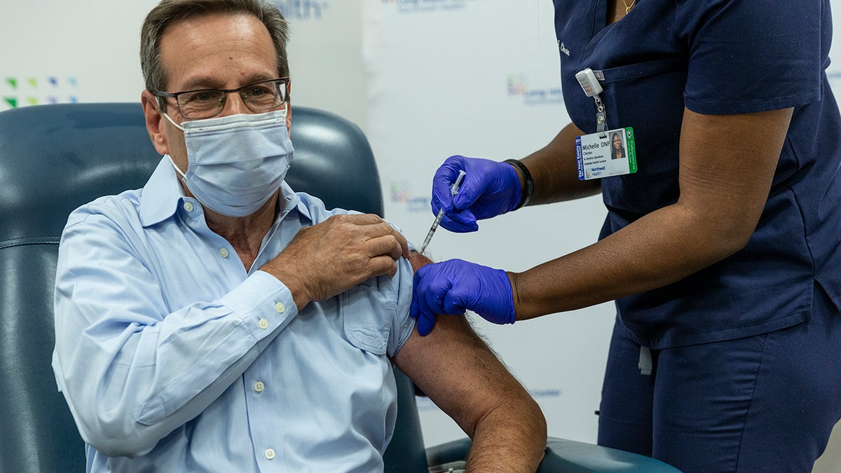Dr. Richard Schwartz receives COVID-19 Pfizer vaccine booster at Teaching Center LIJ Medical Center. The COVID-19 booster shots have the same recipe as the original vaccines.