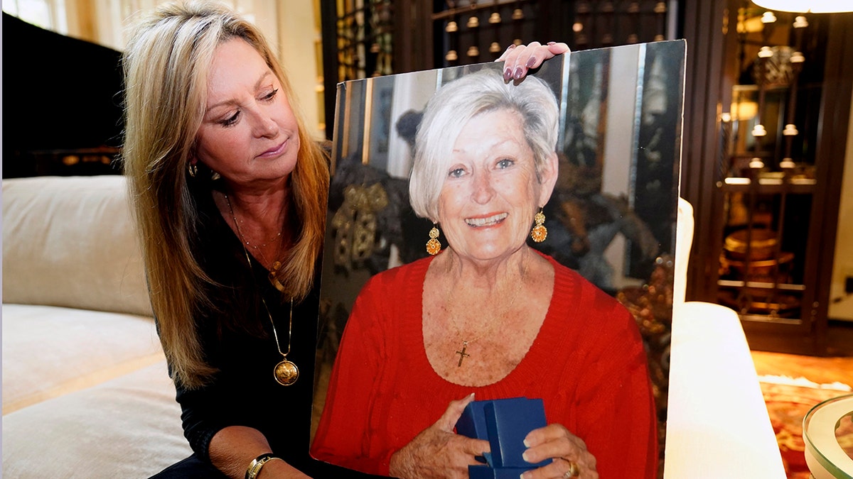 MJ Jennings posing with a photo of her late mother