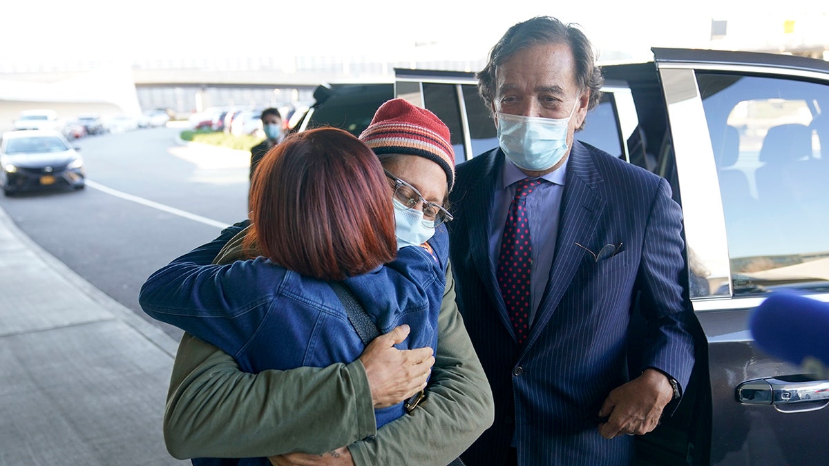 Danny Fenster hugs his mother Rose Fenster as Bill Richardson looks on at John F. Kennedy Airport in New York, Tuesday, Nov. 16, 2021. 