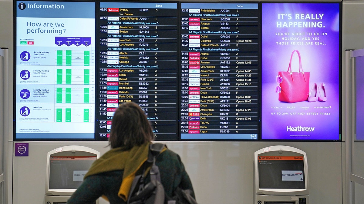 A passenger looks at a departures board at London Heathrow Airport's T3 as the US reopens its borders to UK visitors in a significant boost to the travel sector in London on Monday.