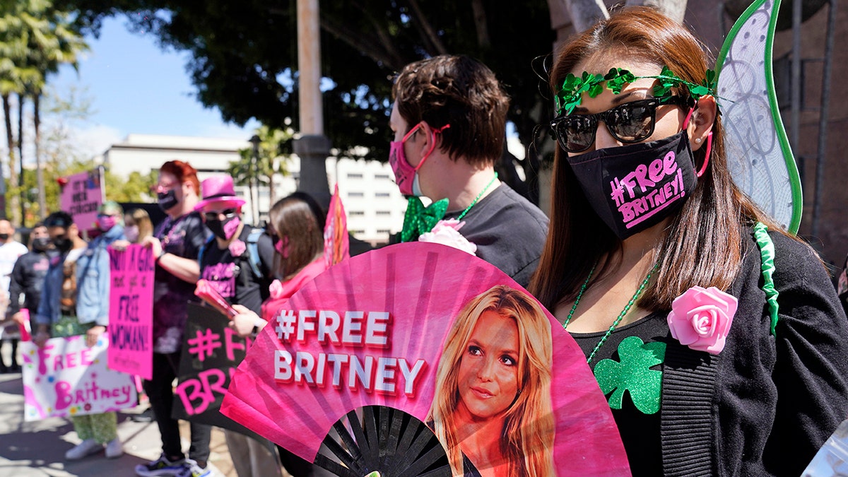 Britney Spears supporter Kiki Norberto holds a hand fan outside a court hearing concerning the pop singer's conservatorship at the Stanley Mosk Courthouse in March in Los Angeles. 