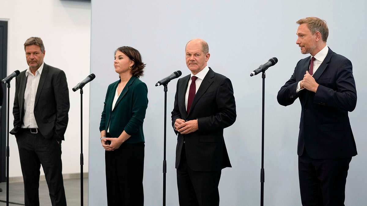 Social Democratic Party chancellor candidate Olaf Scholz, second from right, Green party leaders Annalena Baerbock, second from left, and Robert Habeck, left, and Free Democratic Party chairman Christian Lindner in Berlin on Oct. 15, 2021. 