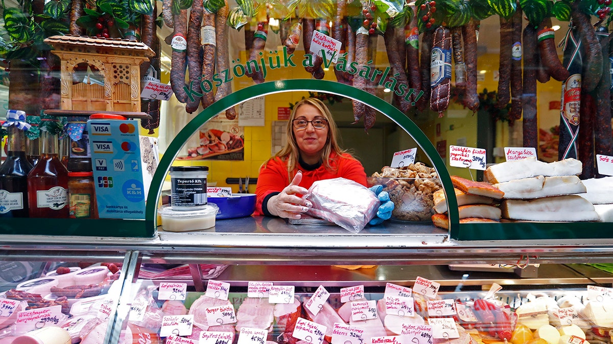 A vendor sells food items at a food market in Budapest, Hungary, on Nov. 20, 2021. 