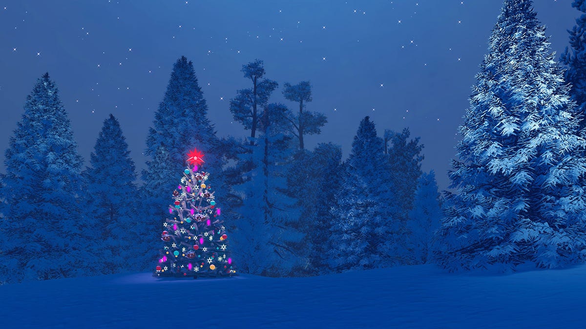 Decorated christmas tree among snowy fir forest at night