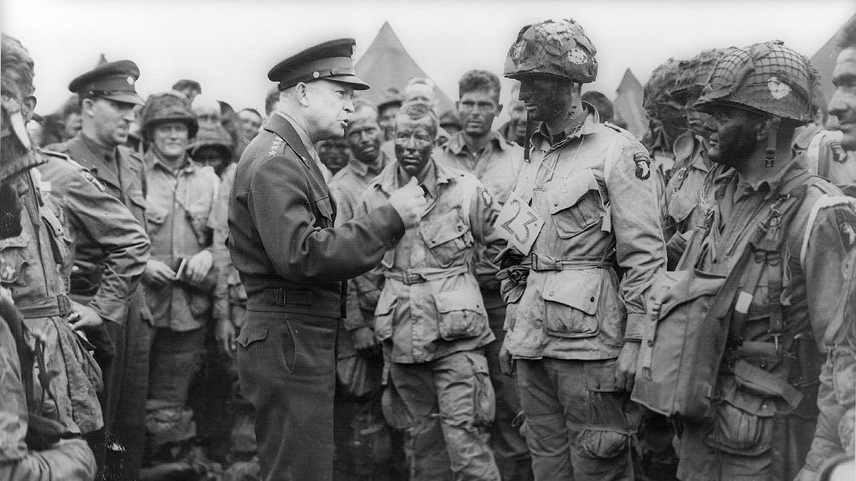 Allied forces Supreme Commander General Dwight D. Eisenhower speaks with U.S. Army paratroopers of Easy Company, 502nd Parachute Infantry Regiment (Strike) of the 101st Airborne Division, at Greenham Common Airfield in England June 5, 1944 in this handout photo provided by the US National Archives. Picture taken June 5, 1944. REUTERS/US National Archives/Handout via Reuters.
