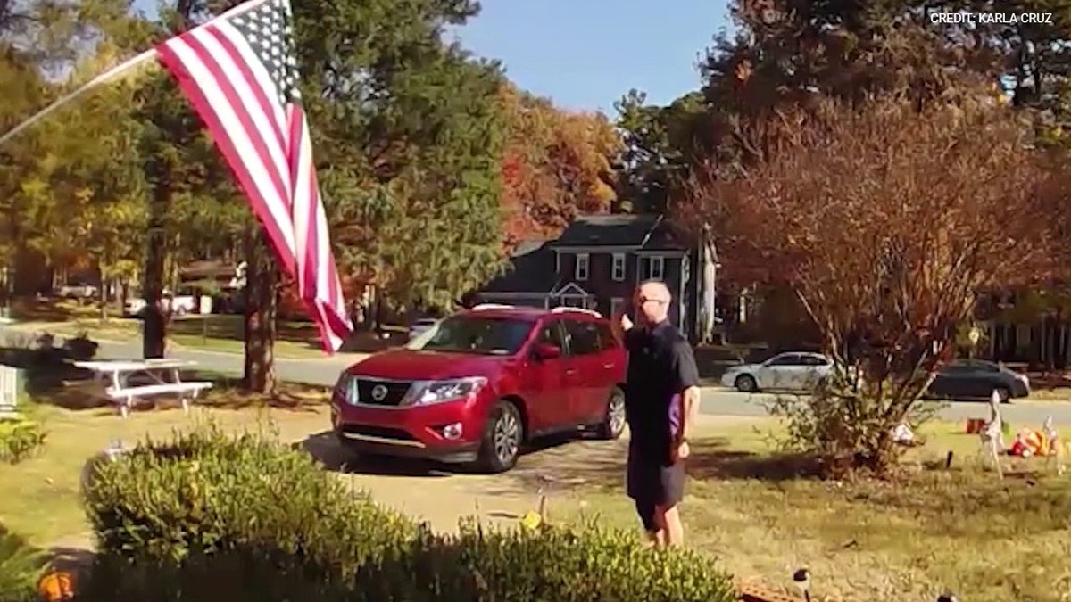 FedEx driver recorded picking up a fallen American flag and saluting it outside a home in Matthews, North Carolina.