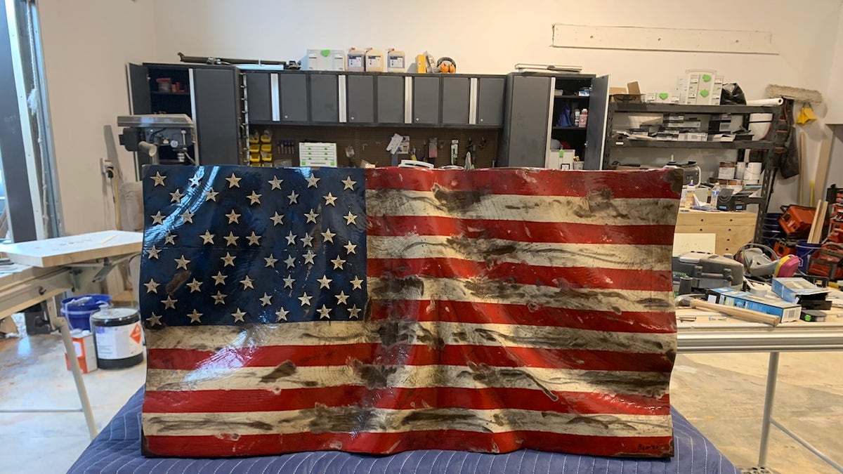 Bear Thomas of Whitedog Woodshop, in Montana, uses scrap wood to craft American flags. November 11, 2021.