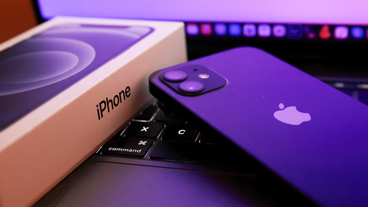 In this photo illustration, Apples iPhone 12 seen placed on a MacBook Pro. Kim Komando recently revealed her tips to organize photos and documents.