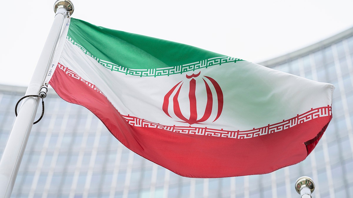 FILE – The flag of Iran waves in front of the International Center building with the headquarters of the International Atomic Energy Agency, IAEA, in Vienna, Austria, Monday, May 24, 2021.  